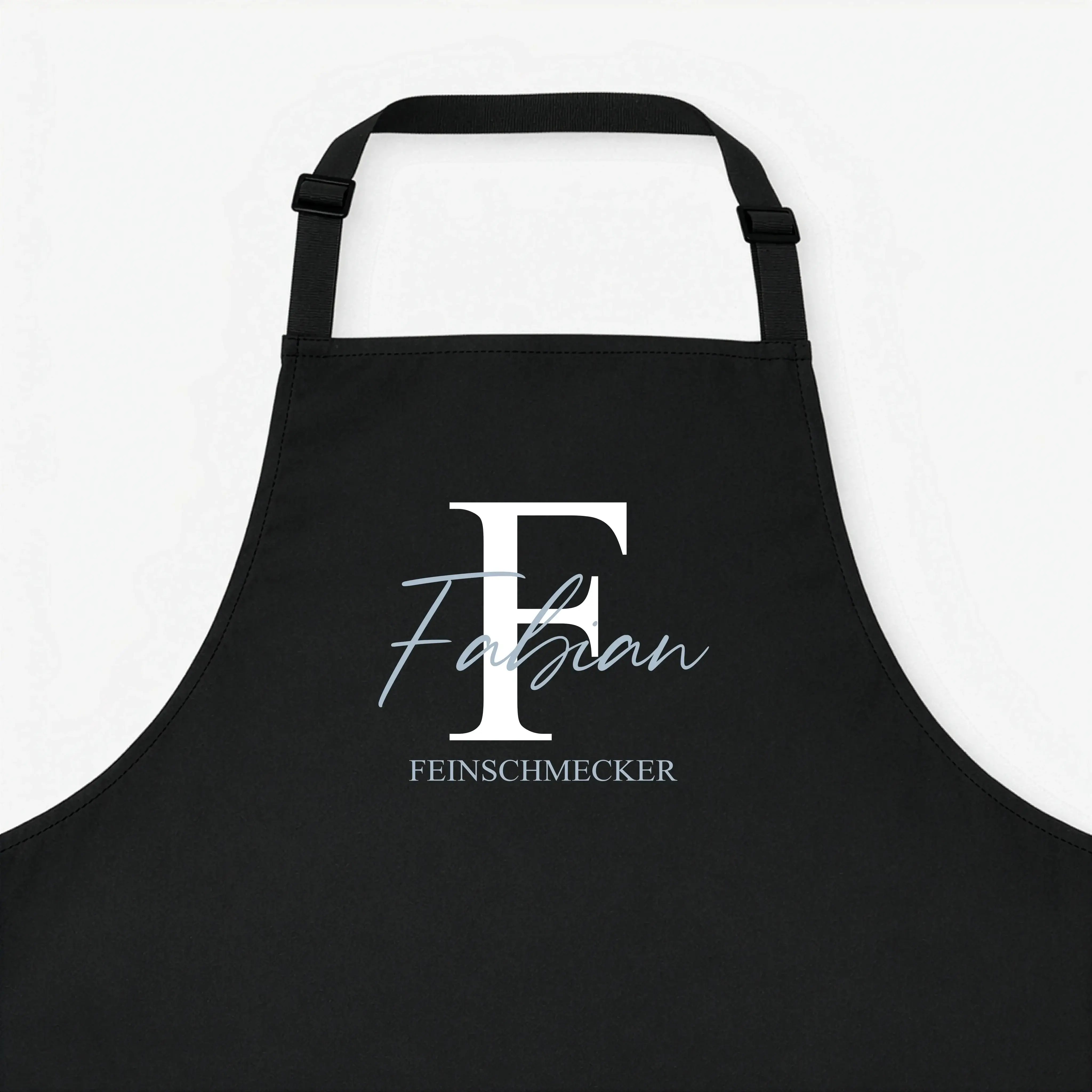 Kochschürze Initial + Text-Kochschürze-famprints-Die Kochschürze Initial + Text von famprints macht aus einem Alltagsprodukt ein persönliches Statement für Küche, Grill oder Backstube. Dein gewähltes Initial bildet den Mittelpunkt des Designs und wird mit